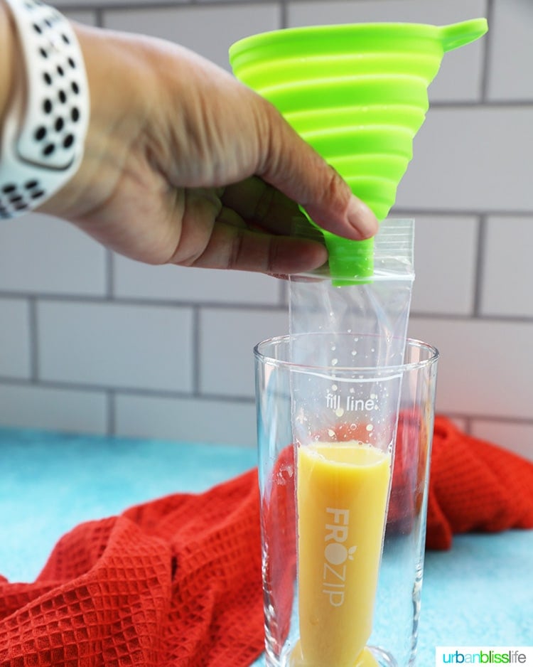 pouring orange juice into freezer pop bag