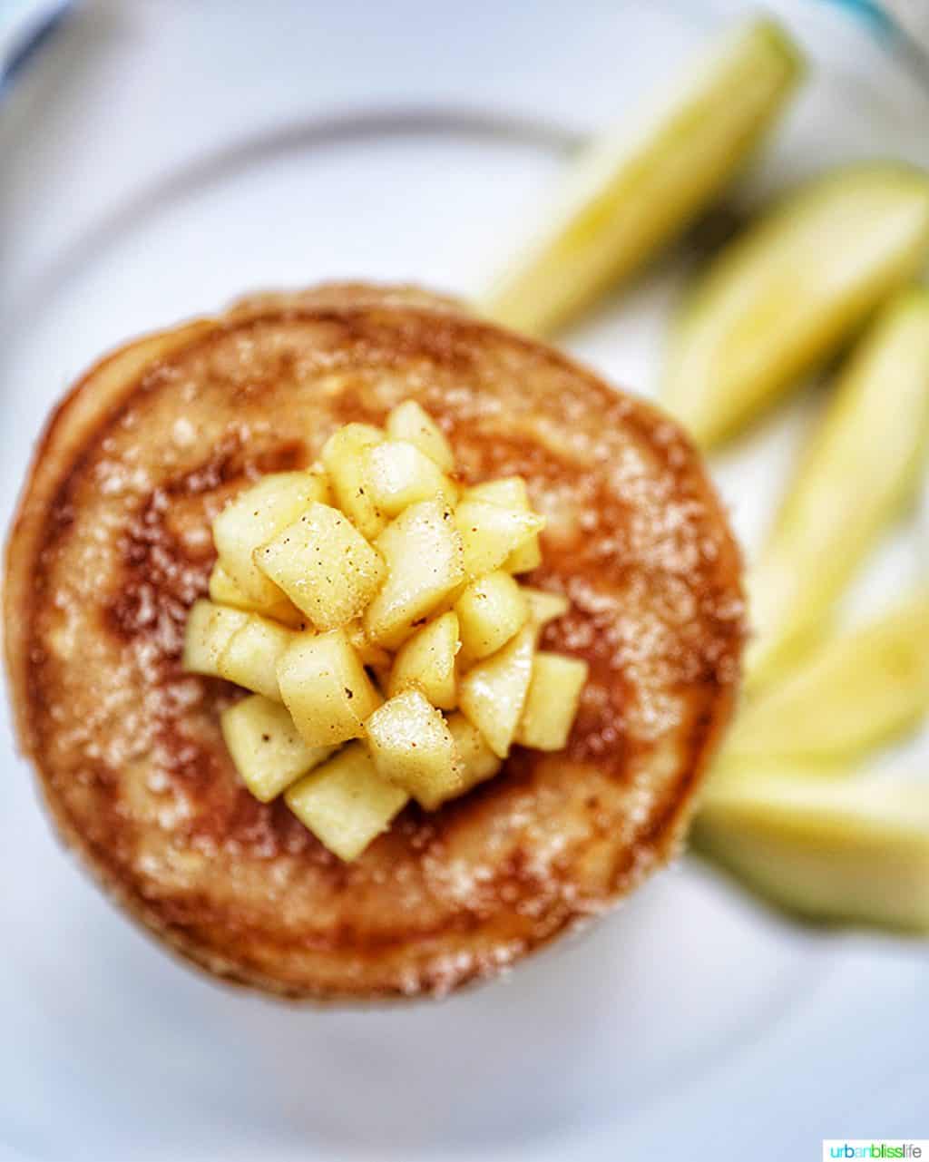 diced apples on top of a stack of pancakes