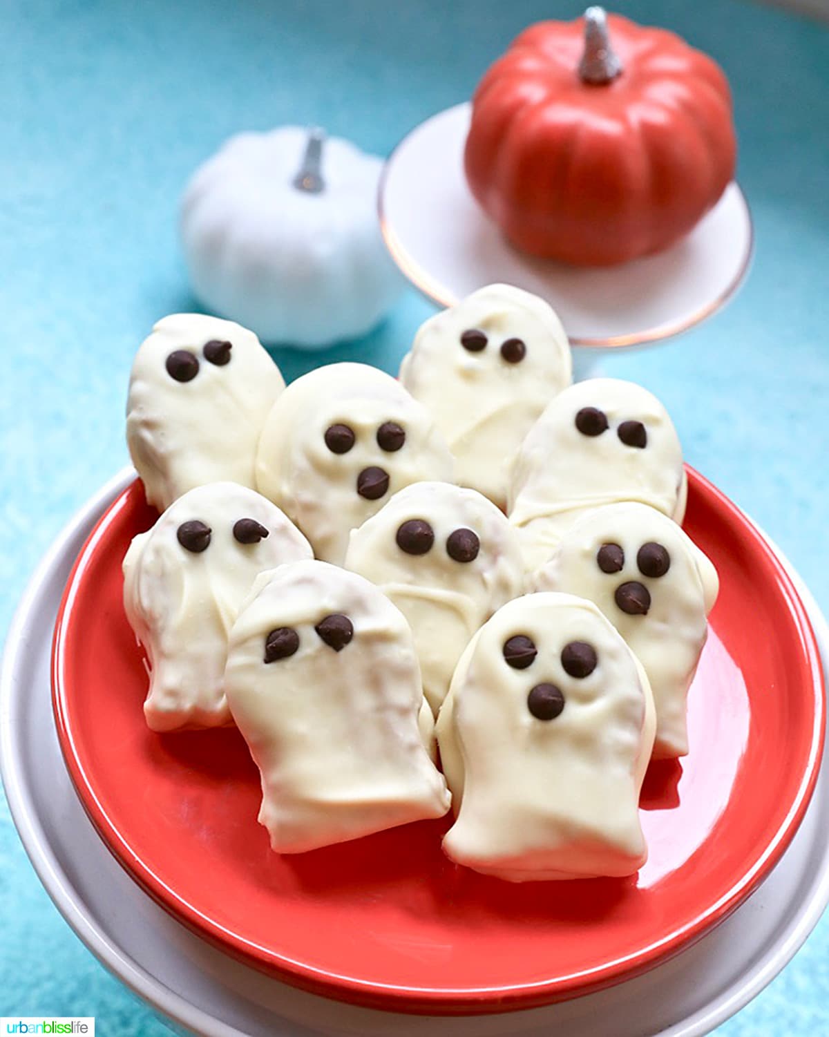 plate of Nutter Butter Ghost Cookies with pumpkins in background