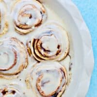 half pan of orange cinnamon rolls with icing