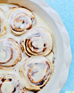 half pan of orange cinnamon rolls with icing
