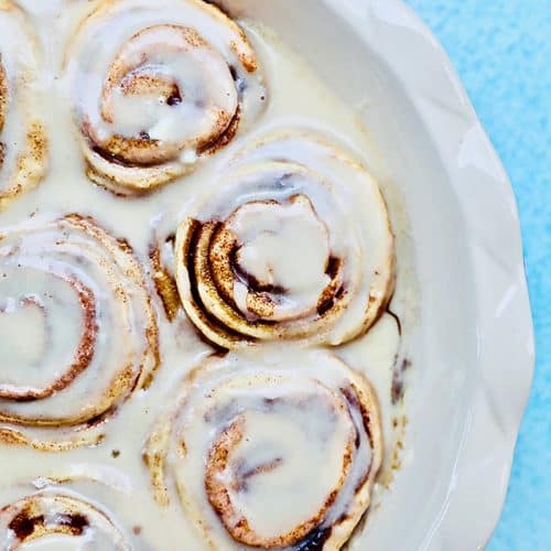 half pan of orange cinnamon rolls with icing