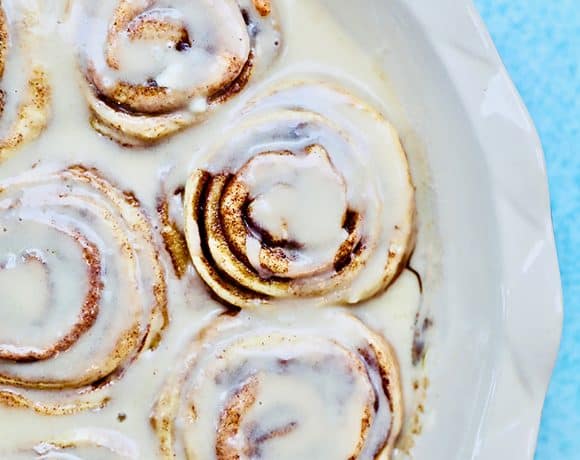 half pan of orange cinnamon rolls with icing