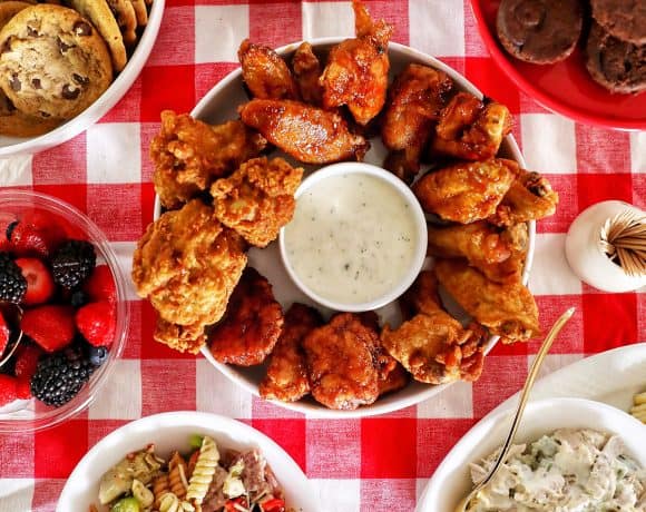 tailgating food on red checkered tablecloth