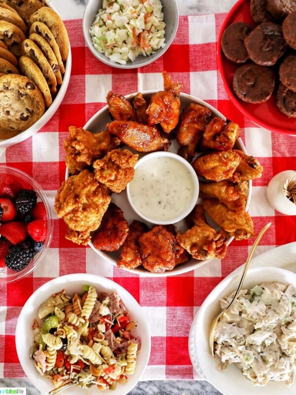 tailgating food on red checkered tablecloth