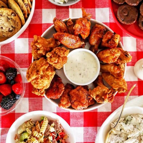 tailgating food ideas: chicken wings, pasta salad, chicken salad, cookies, brownies