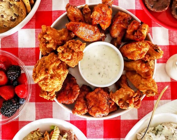 tailgating food ideas: chicken wings, pasta salad, chicken salad, cookies, brownies