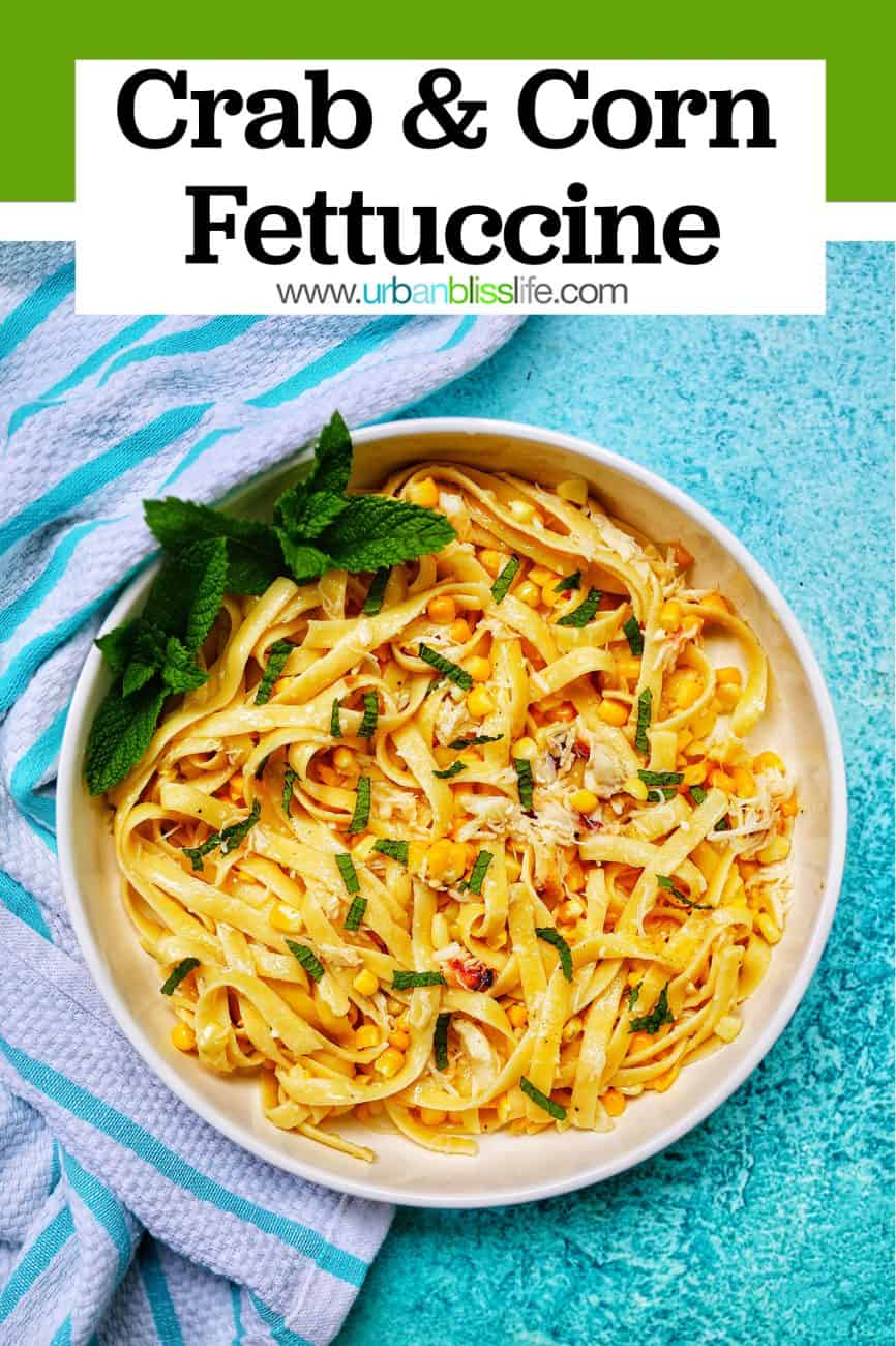 crab and corn fettuccine in bowl on blue background with title text