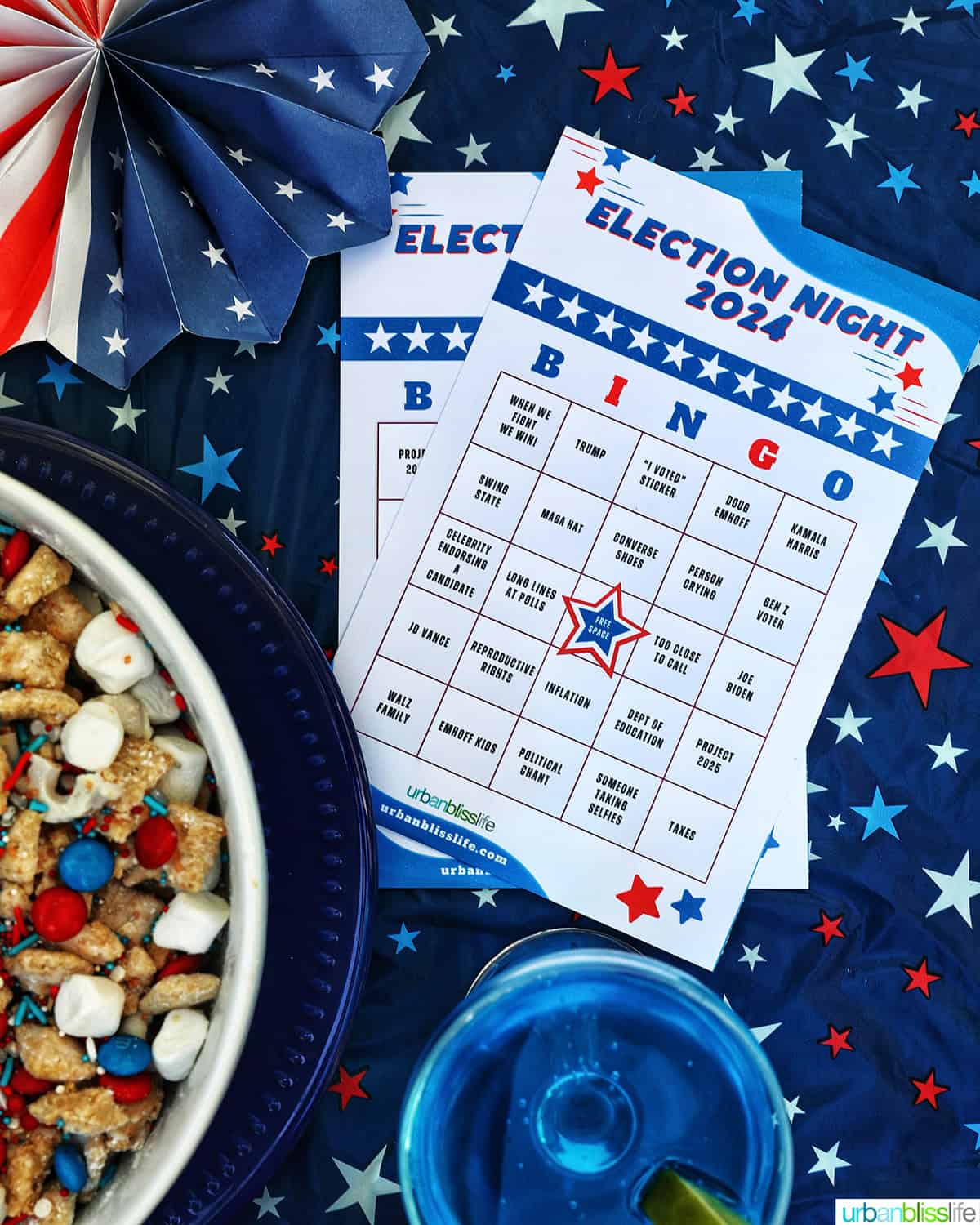 election bingo cards next to a blue wave cocktail and bowl of red, white, and blue trail mix.