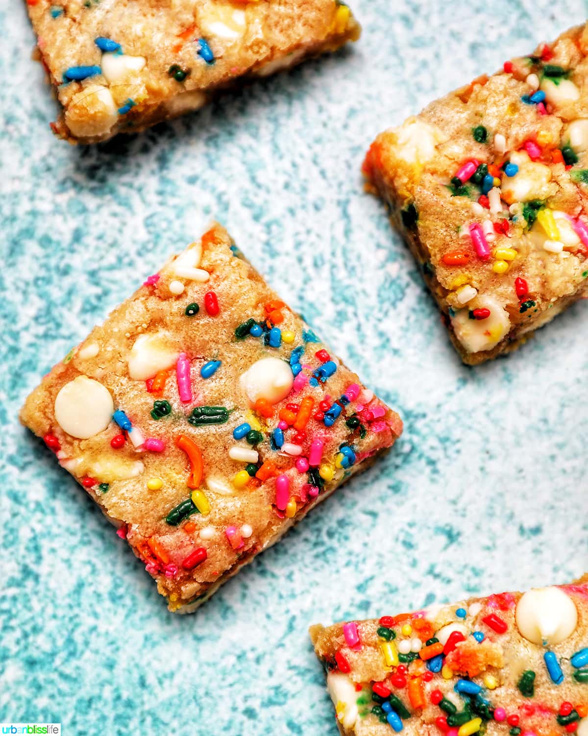 Funfetti Cookie Bars sliced on blue background