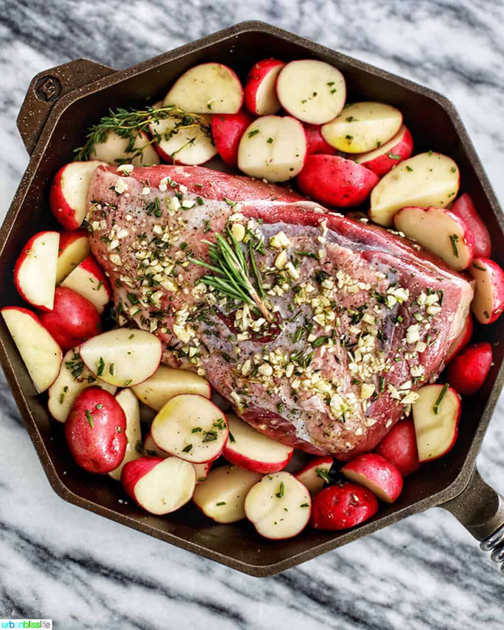 Garlic Rosemary Sirloin Tip Roast with potatoes in Finex cast iron skillet
