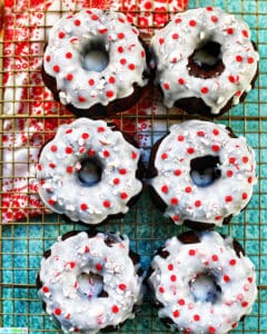 six mini gingerbread bundt cakes on a baking rack with red and white napkin