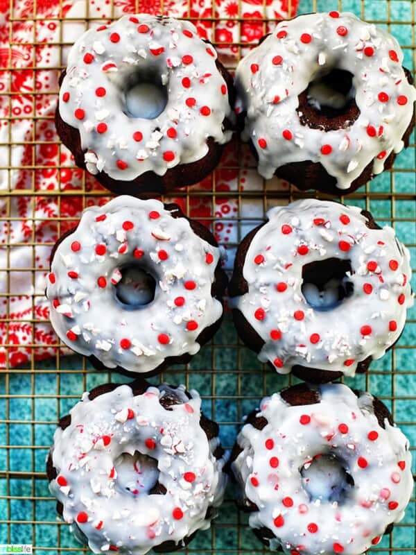 six mini gingerbread bundt cakes on a baking rack with red and white napkin