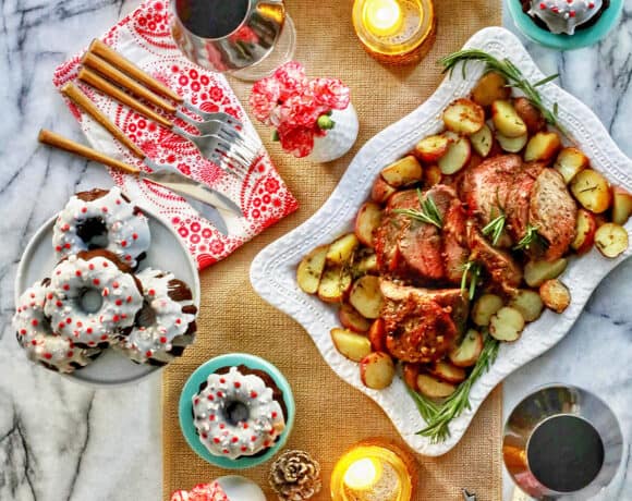 easy holiday meal at home - beef roast, carrots, rolls, glasses of wine, and plates of cake