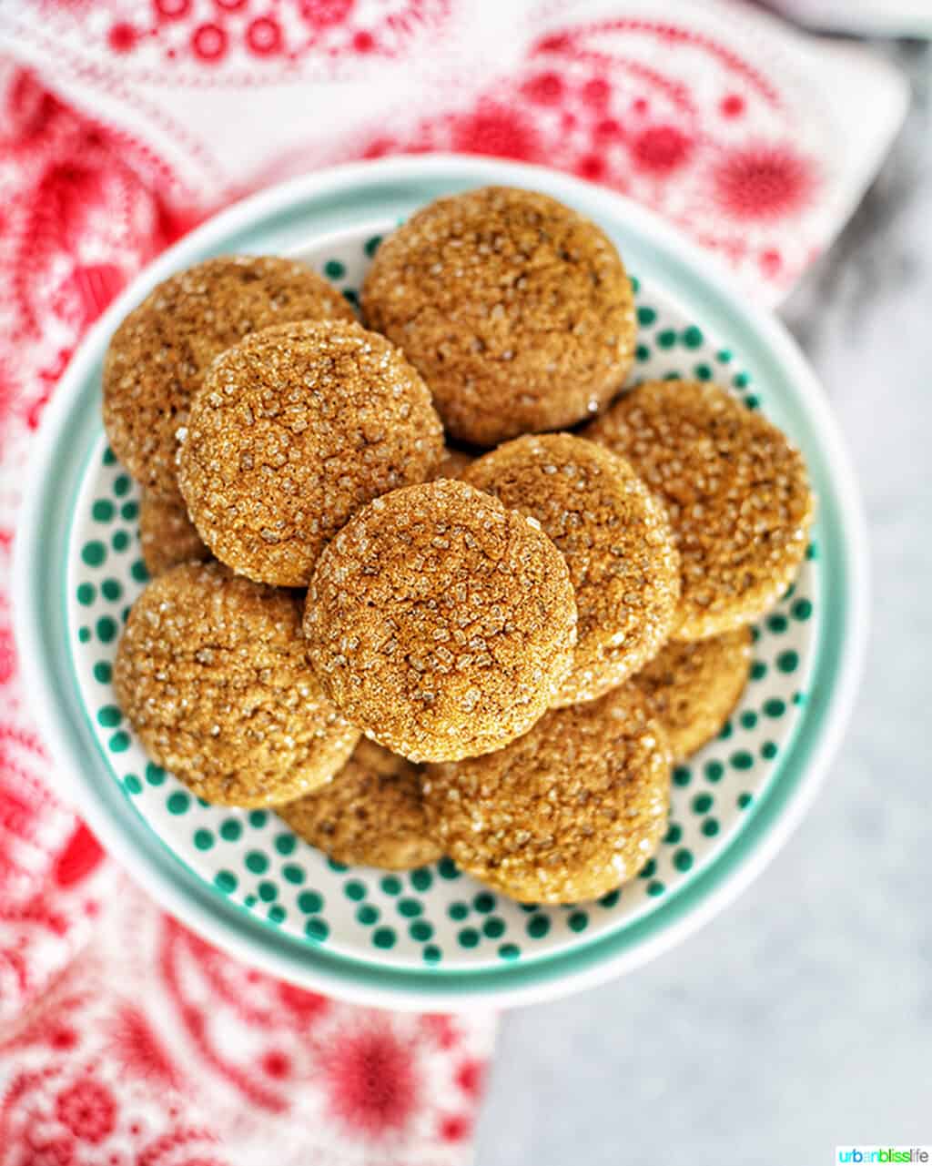 chewy ginger molasses cookies stacked on a plate