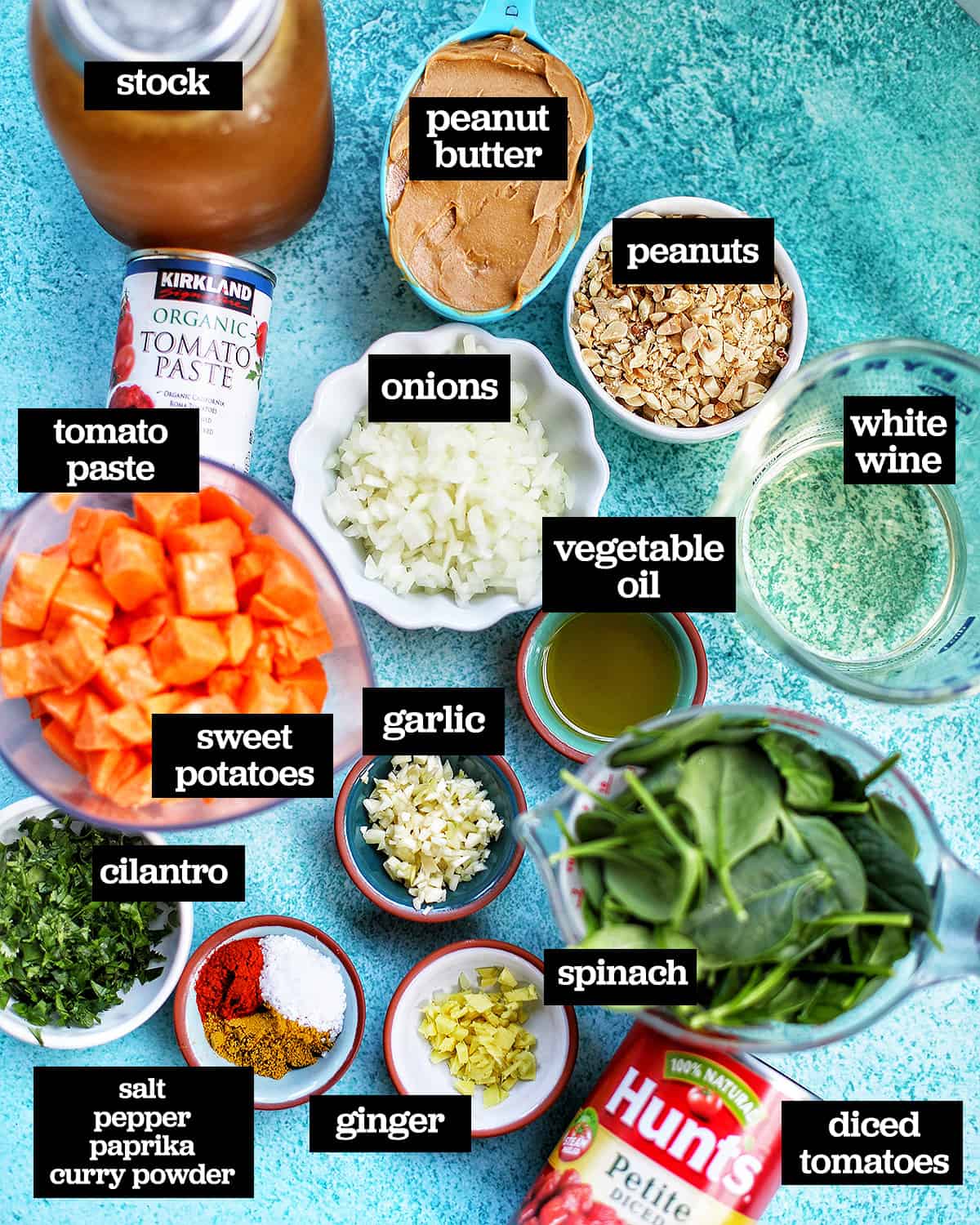 individual ingredients to make Instant Pot African Peanut Stew, all on a bright blue table.