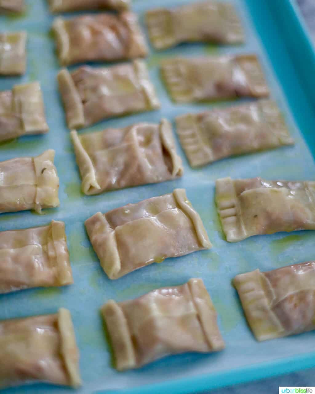 prepped air fryer pizza rolls on blue baking sheet