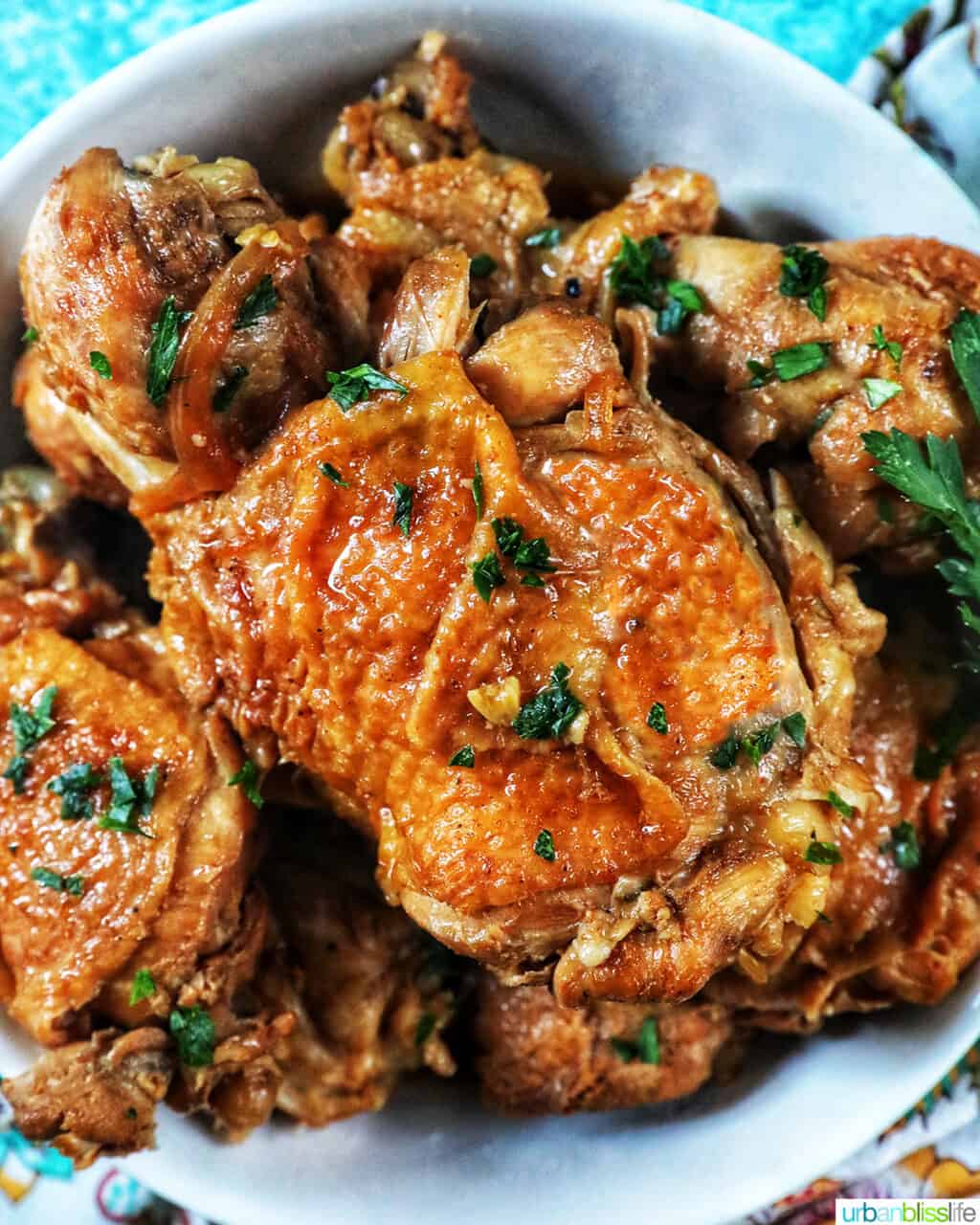 bowl of Instant Pot Filipino Chicken Adobo with herbs.