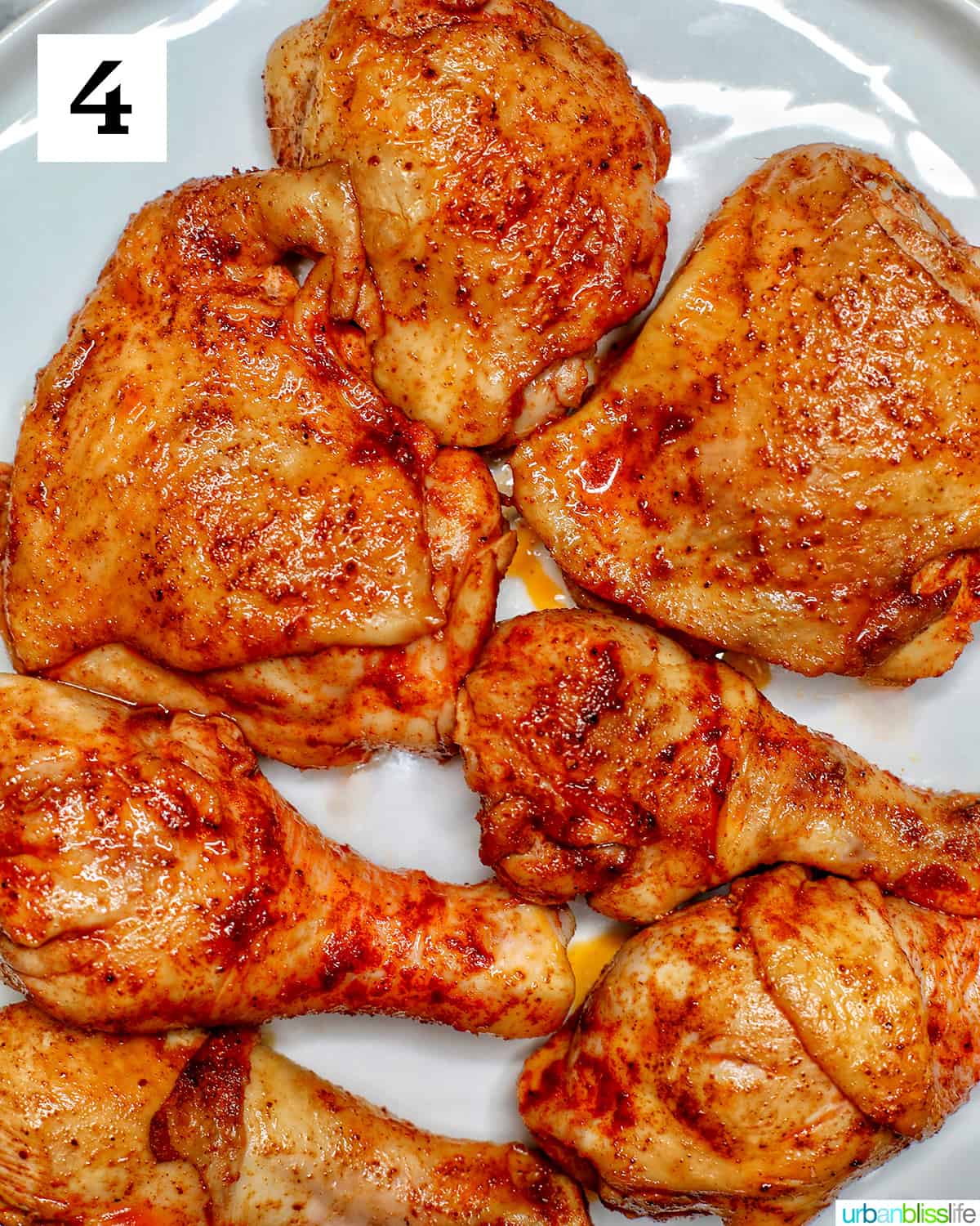 browned seasoned adobo chicken pieces transferred to a plate.
