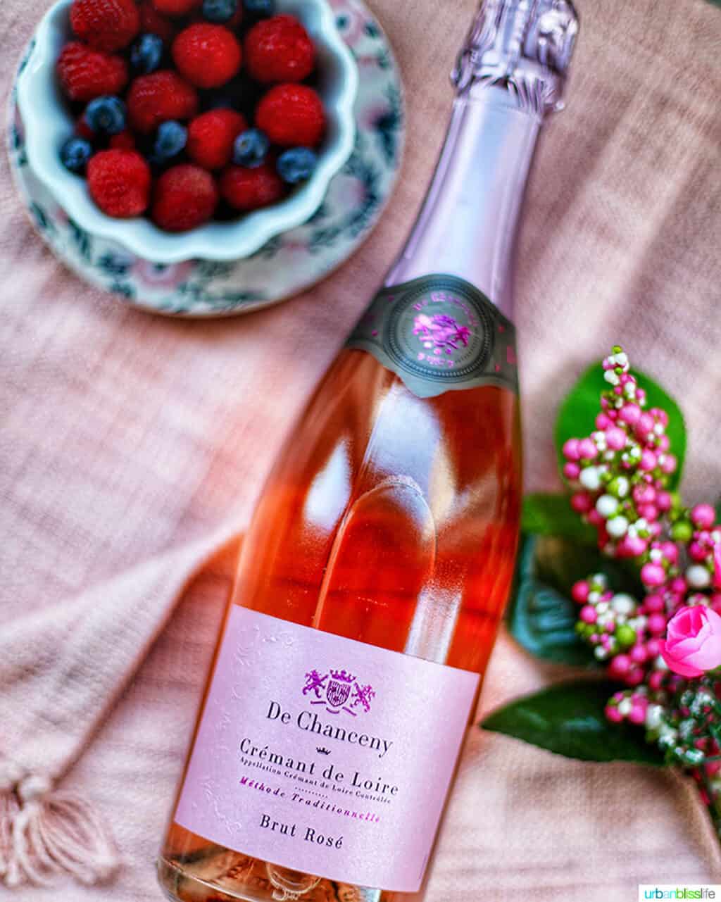 De Chanceney Cremant de Loire bottle with flowers and bowl of fruit