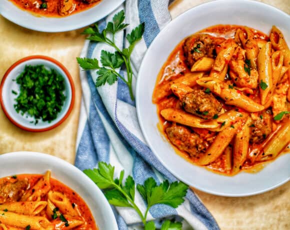 bowls of Instant Pot Cajun Chicken Pasta with greenery