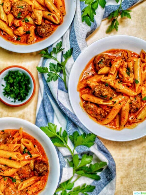 bowls of Instant Pot Cajun Chicken Pasta with greenery