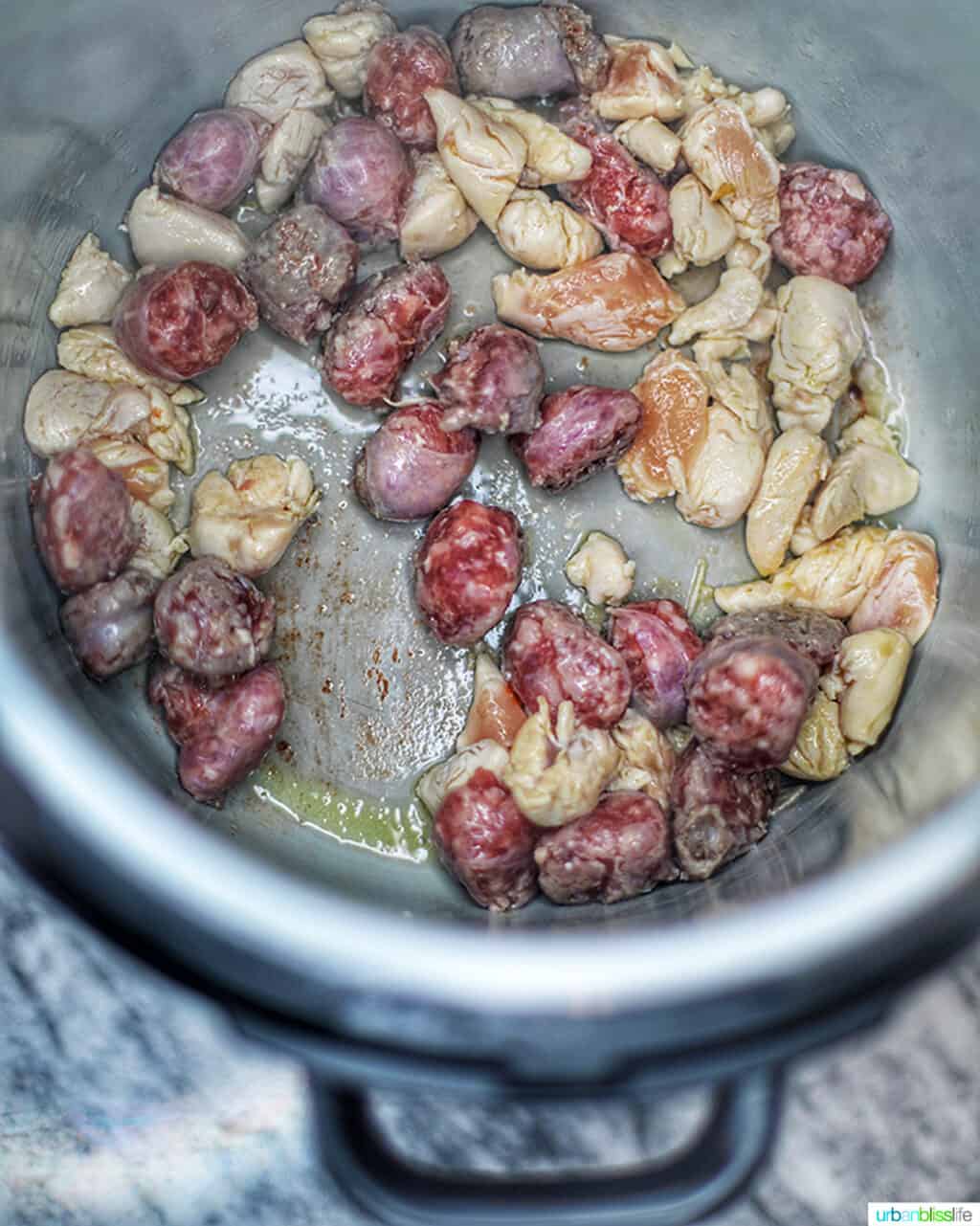sausage and chicken cooking in the Ninja Foodi