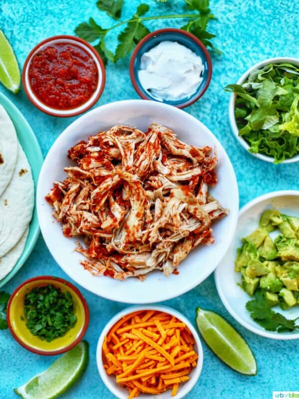 Instant Pot Salsa Chicken with salsa, sour cream, cheese, and other toppings for tacos