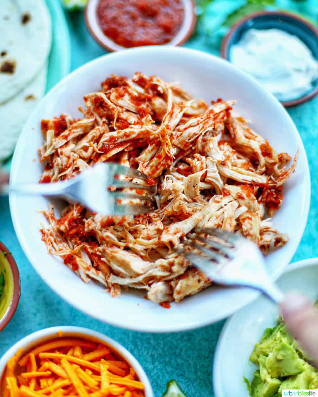 two forks shredding Instant Pot Salsa Chicken