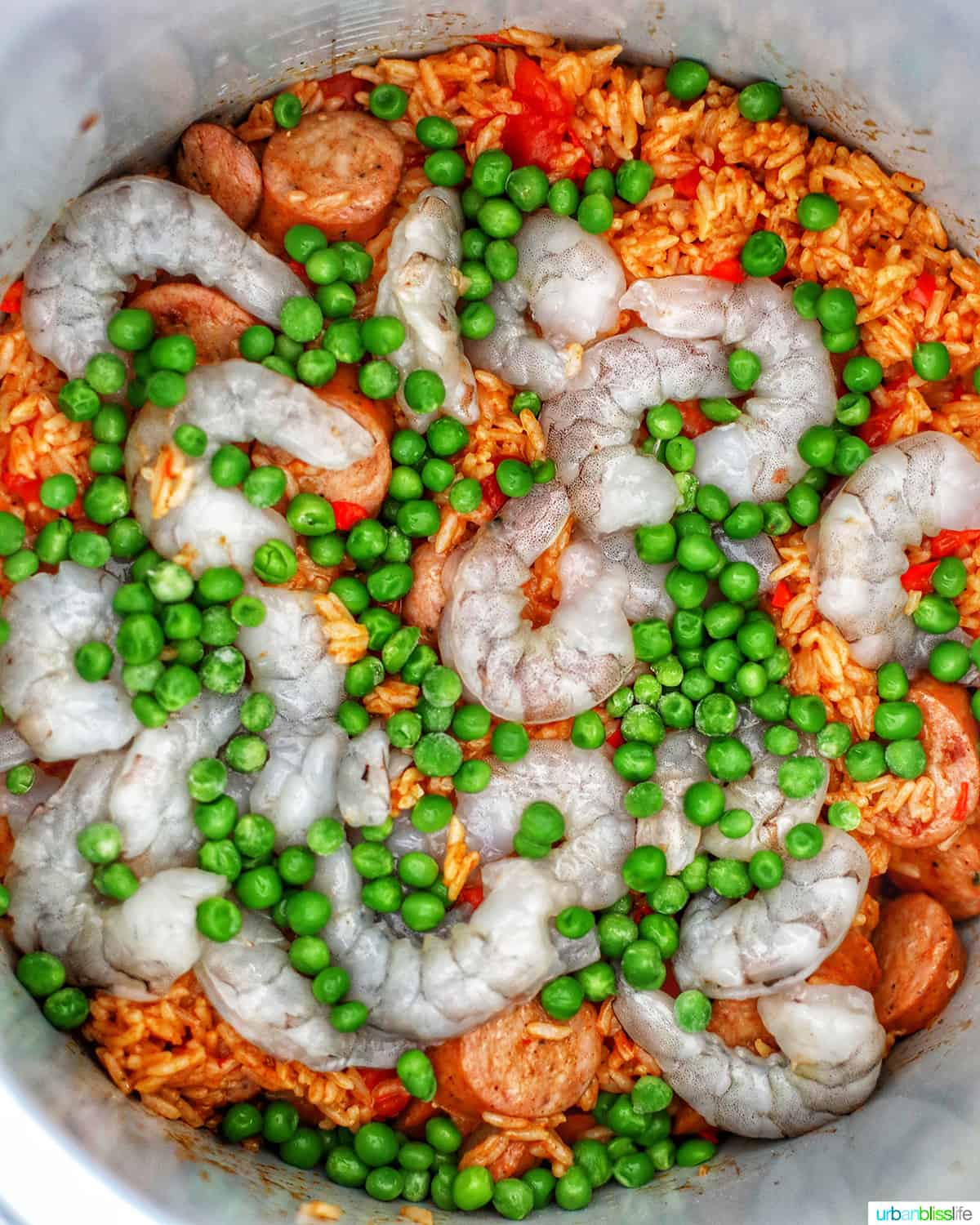 shrimp, peas, and seasoned rice with sausages to make jambalaya in an Instant Pot.
