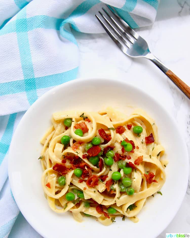 Fettuccine with Bacon and Peas in a bowl with a fork