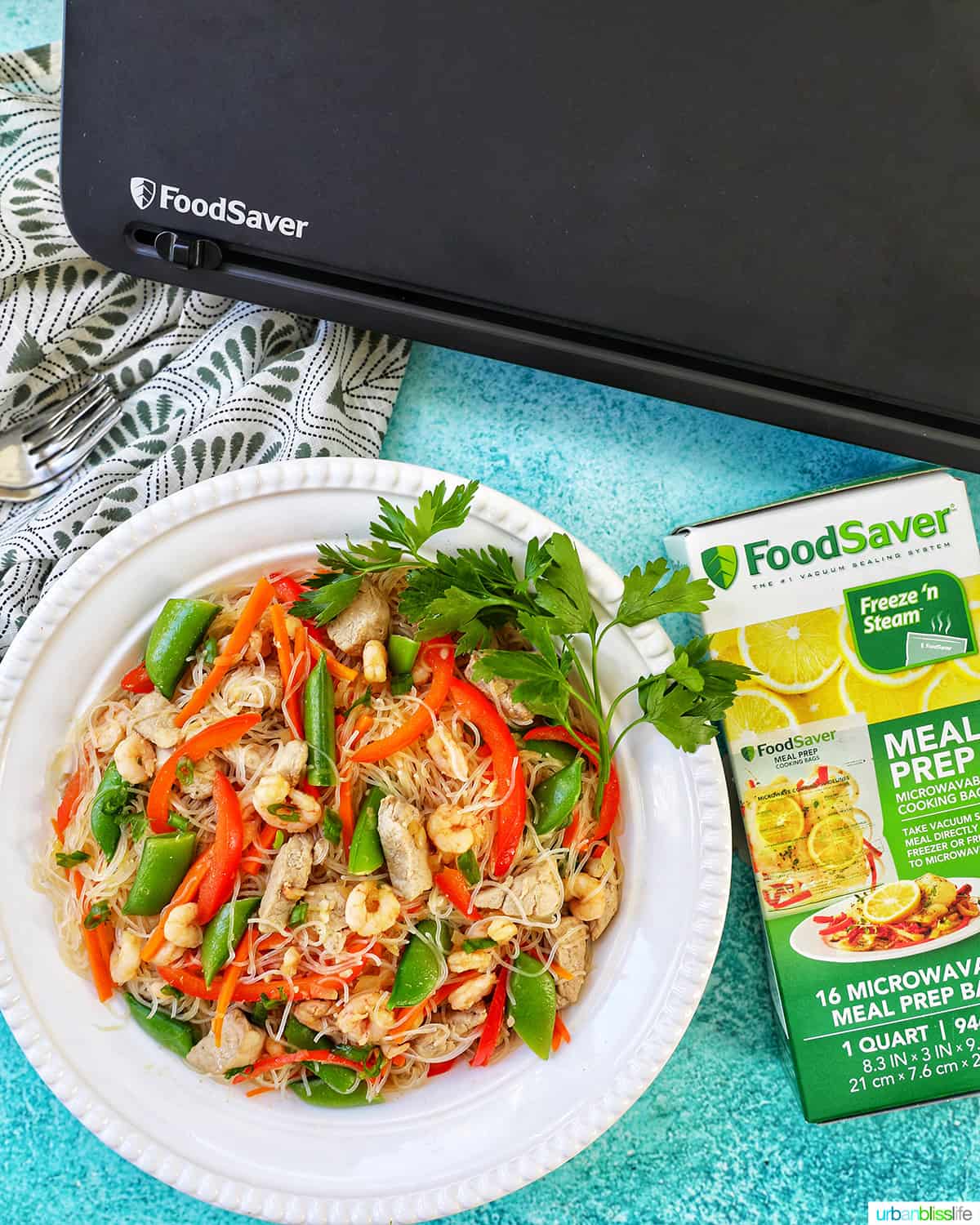 bowl of Filipino Pancit Bihon with FoodSaver machine and Meal Prep Bags