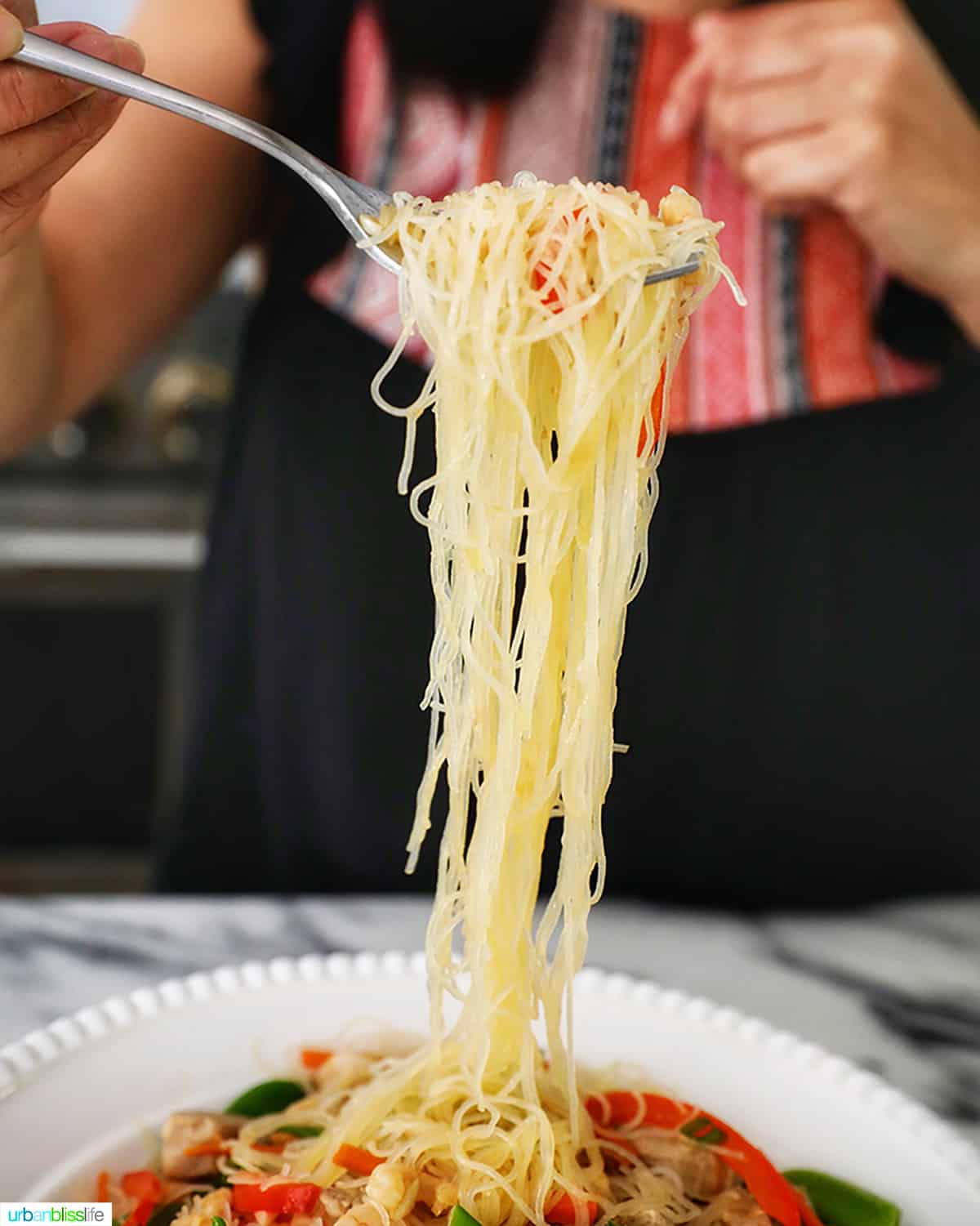 noodle pull of Filipino Pancit Bihon