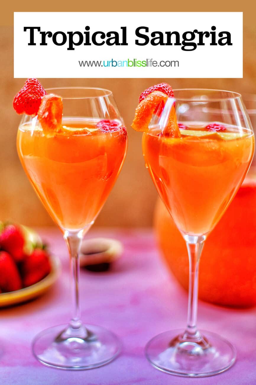 two glasses of tropical sangria with text overlay