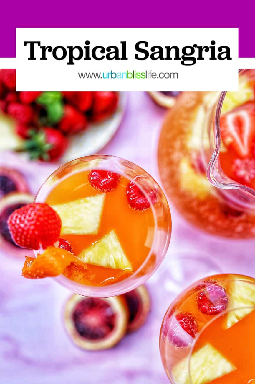 glasses and carafe of tropical sangria with text