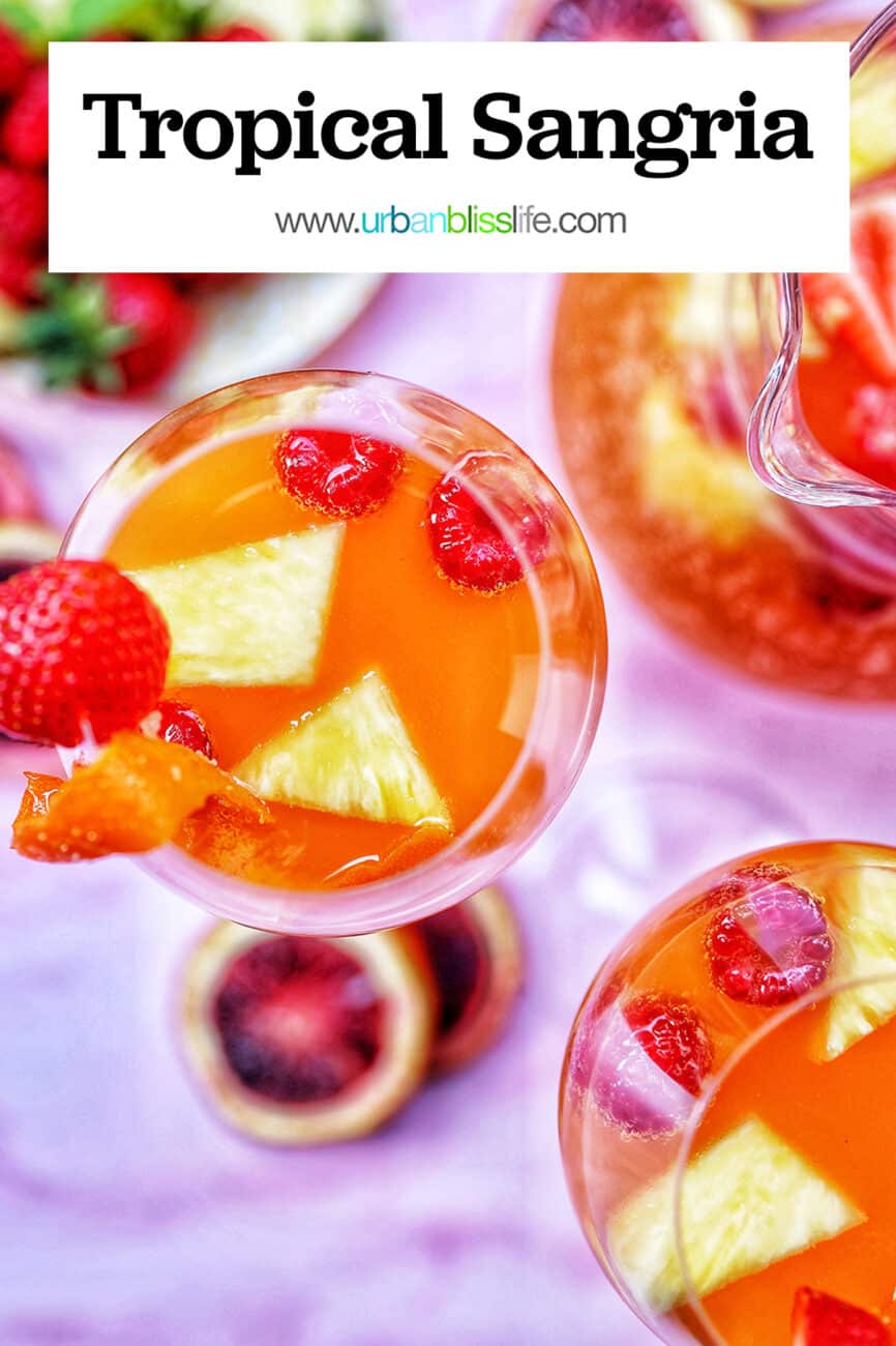 glasses and carafe of tropical sangria with text
