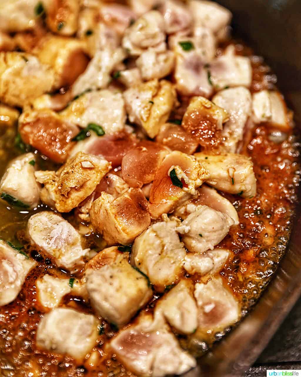chicken cooking in a pan