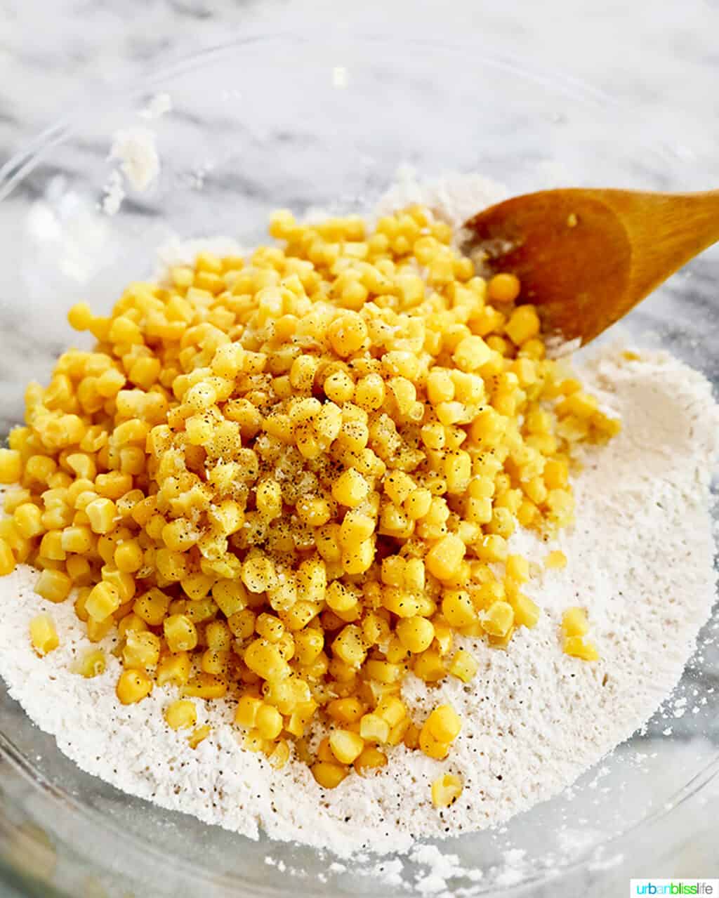mixing corn into corn fritter batter