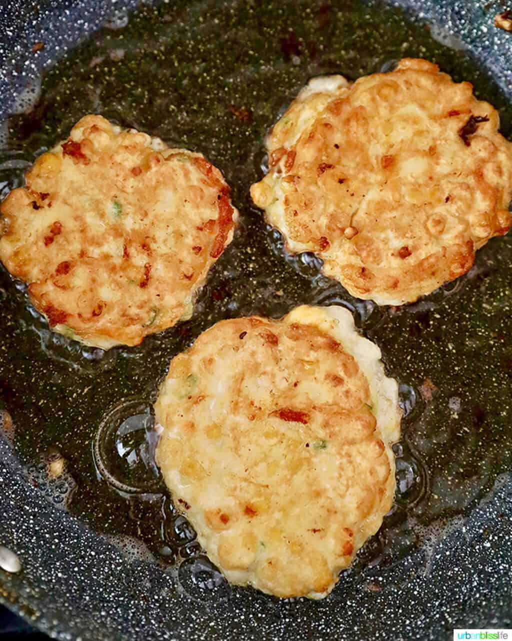 frying corn fritters in pan