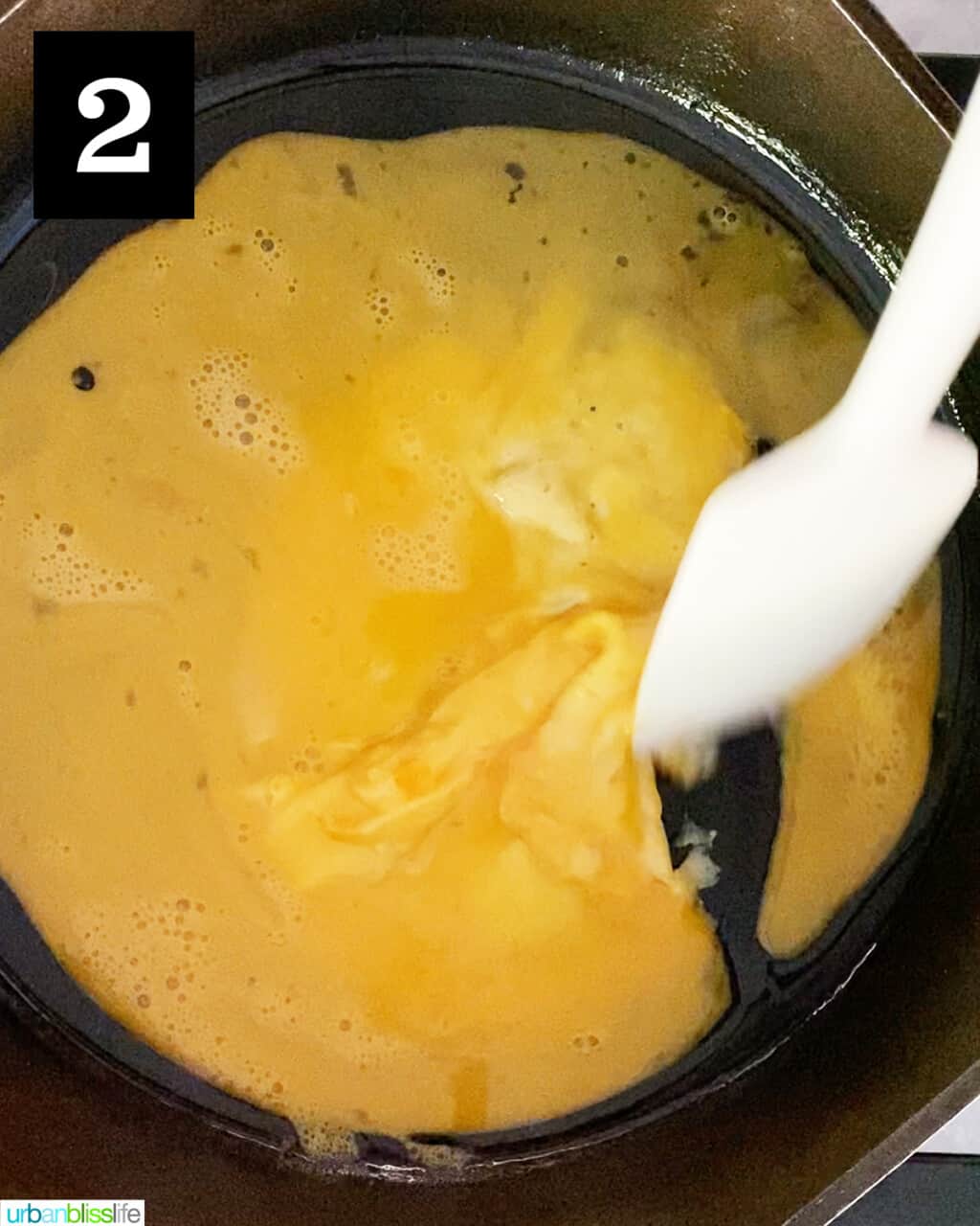 scrambling eggs in a cast iron skillet
