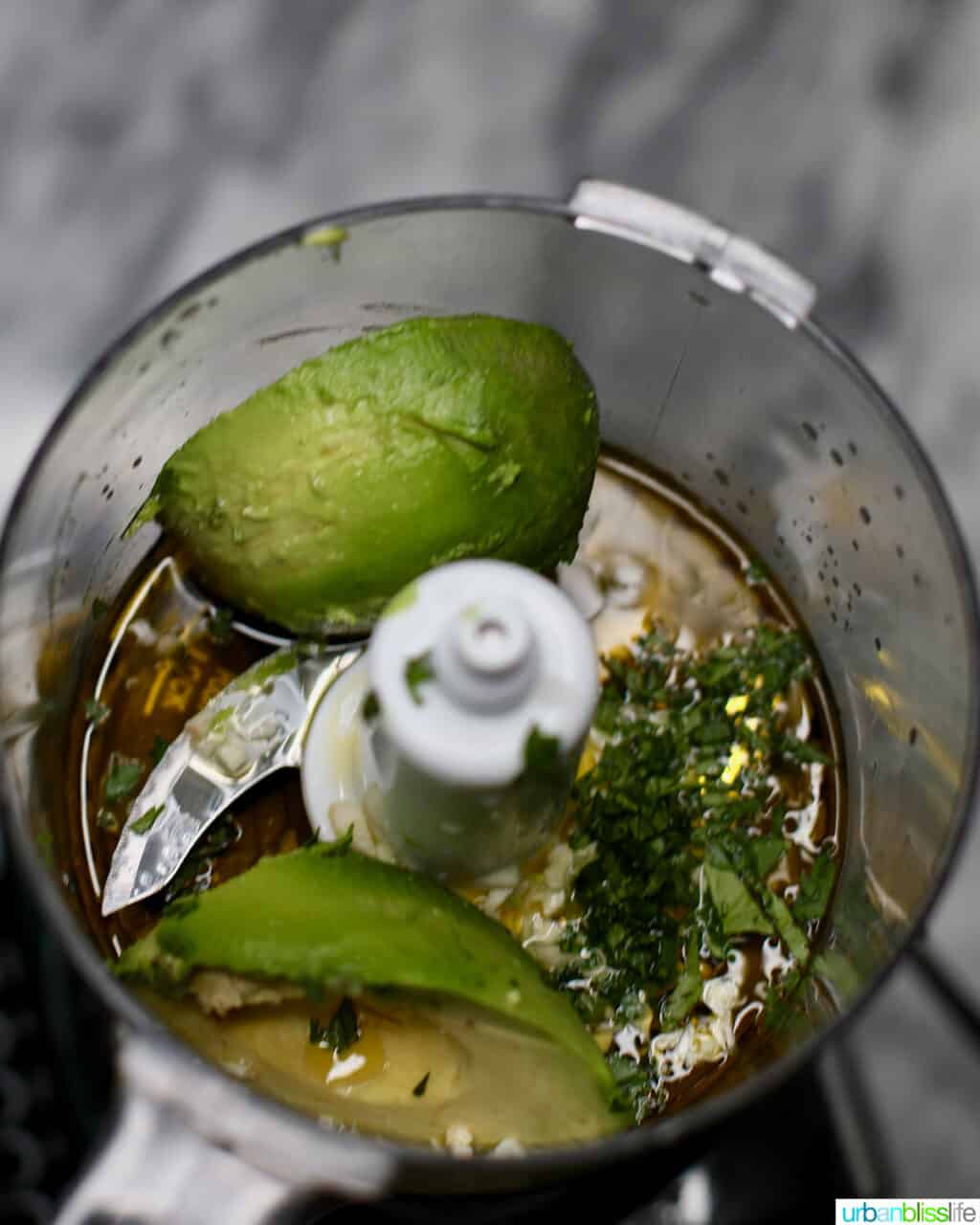avocados and ingredients for pasta salad sauce in a food processor