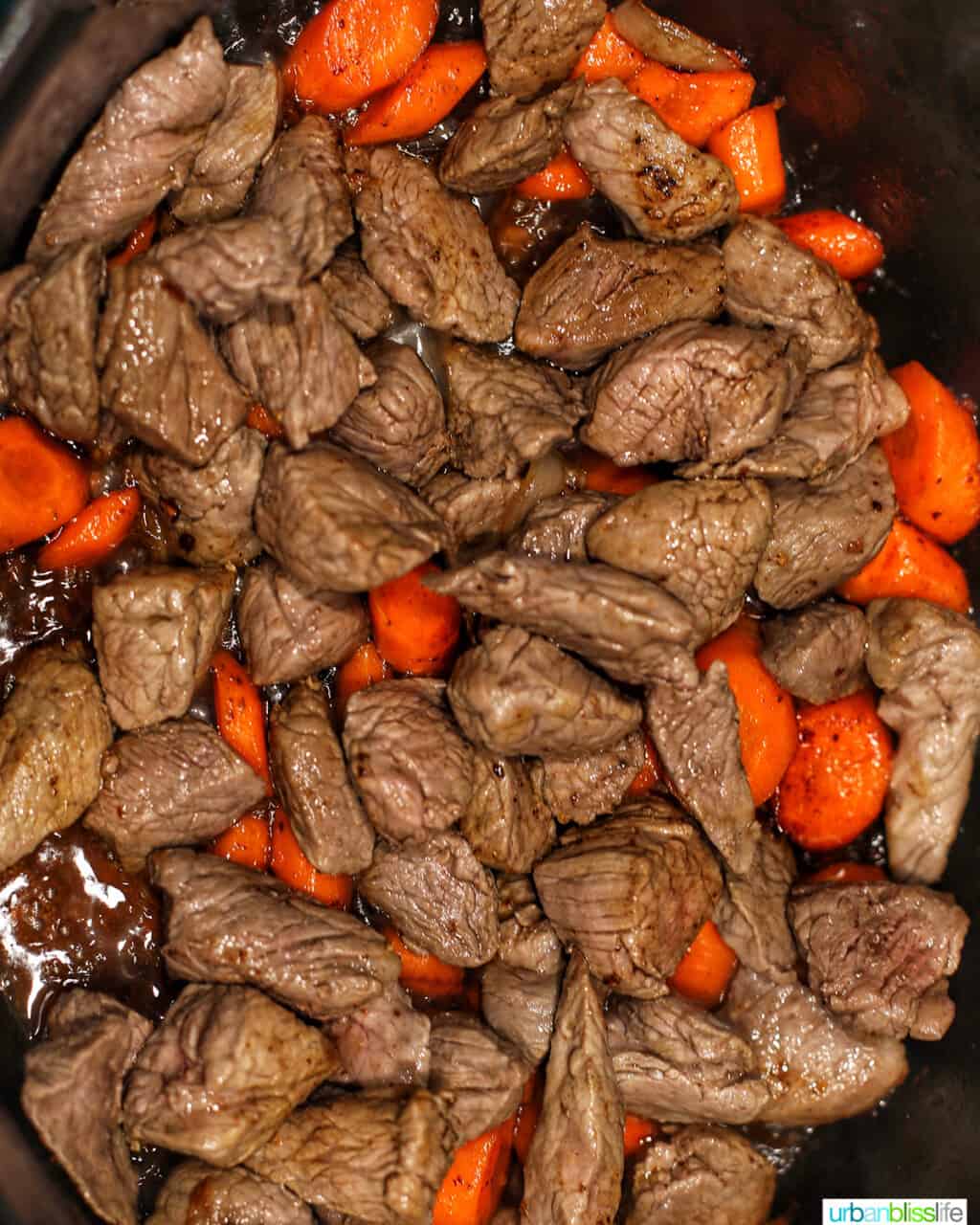 stew meat and carrots in dutch oven