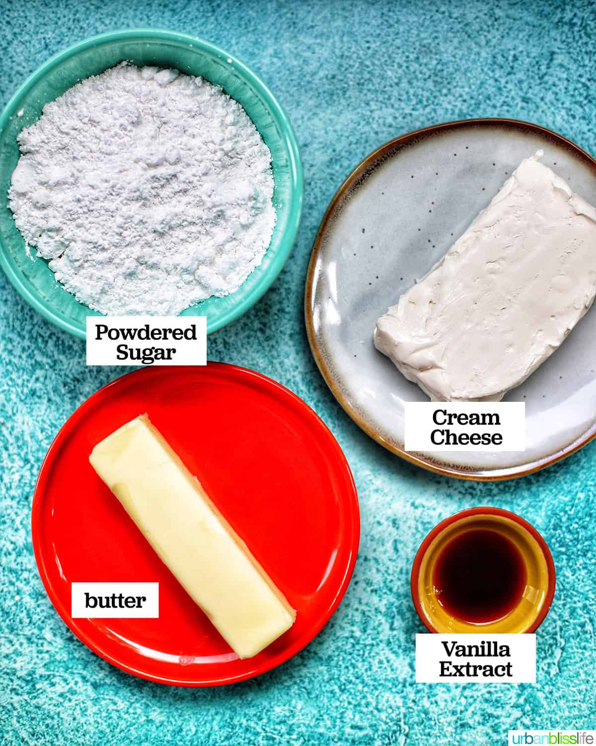 ingredients for cream cheese filling in bowls on a blue table.