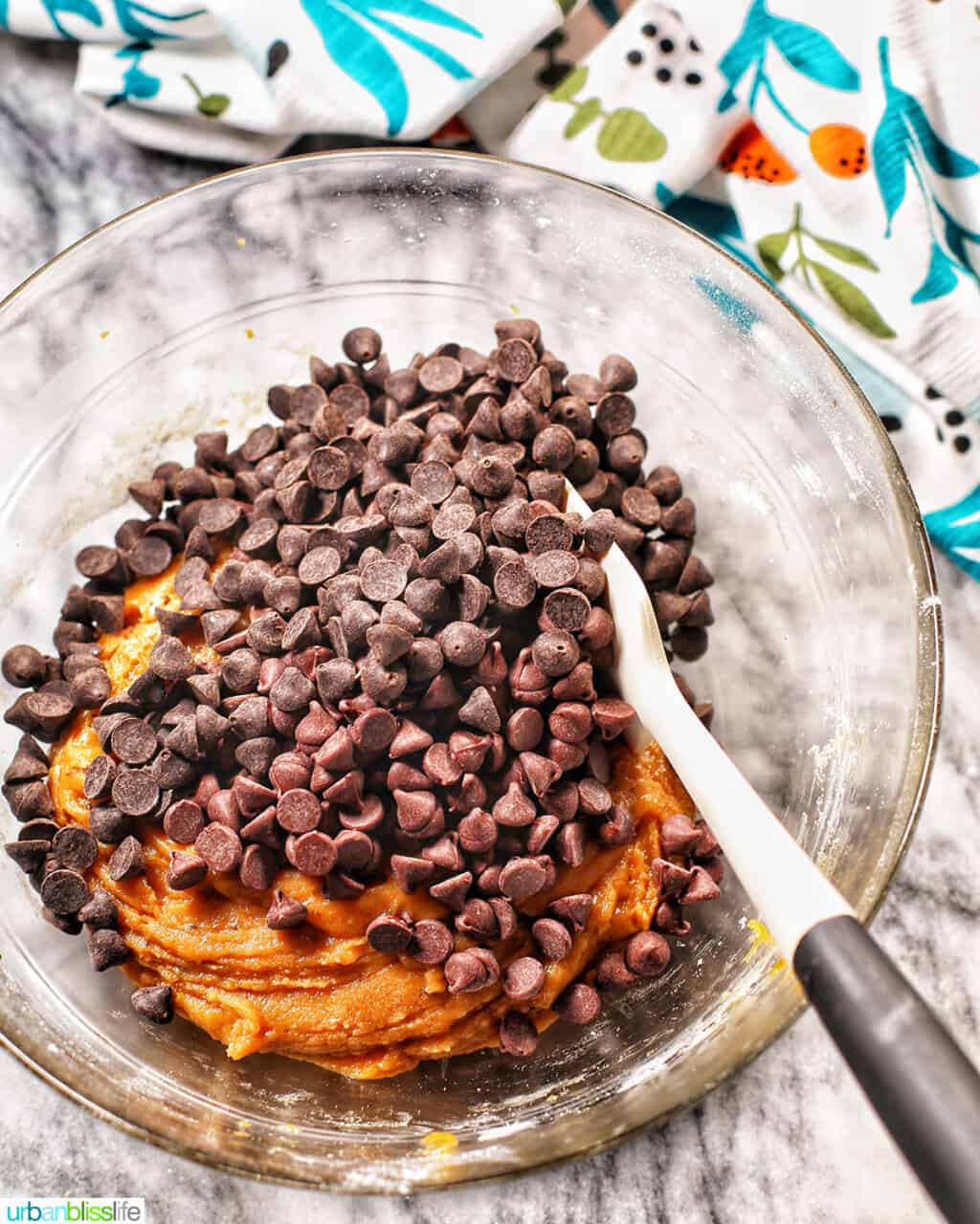 folding in chocolate chips into cookie batter