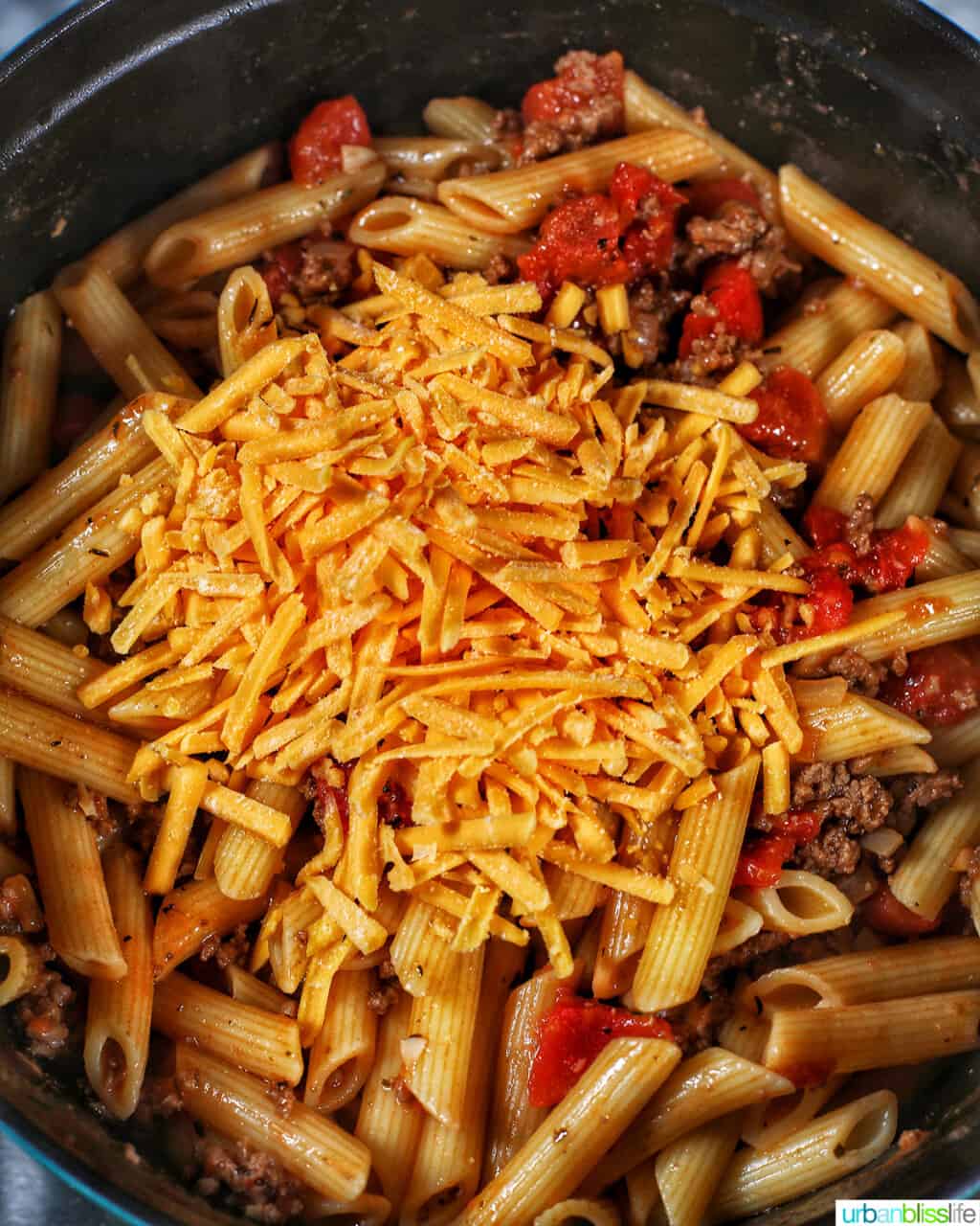 adding dairy-free cheddar shreds to pasta