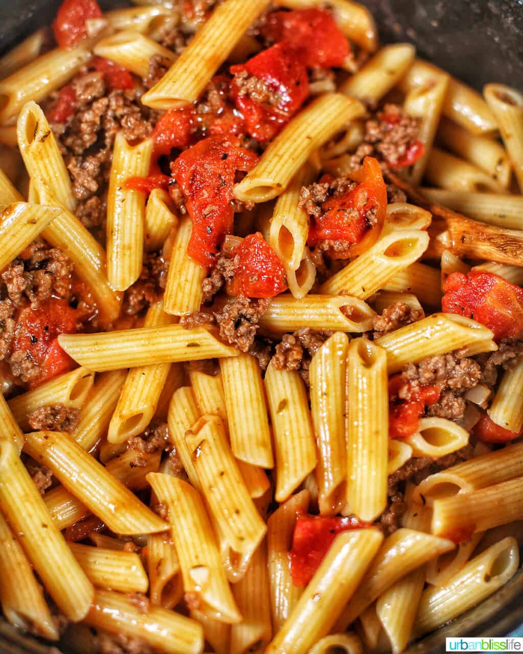 mixing pasta with meat sauce