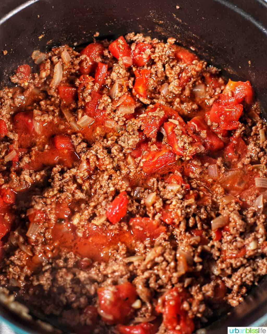 adding tomatoes to ground beef