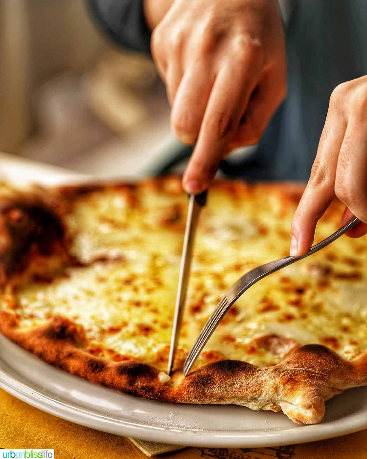 slicing into a pizza in Lugano, Switzerland