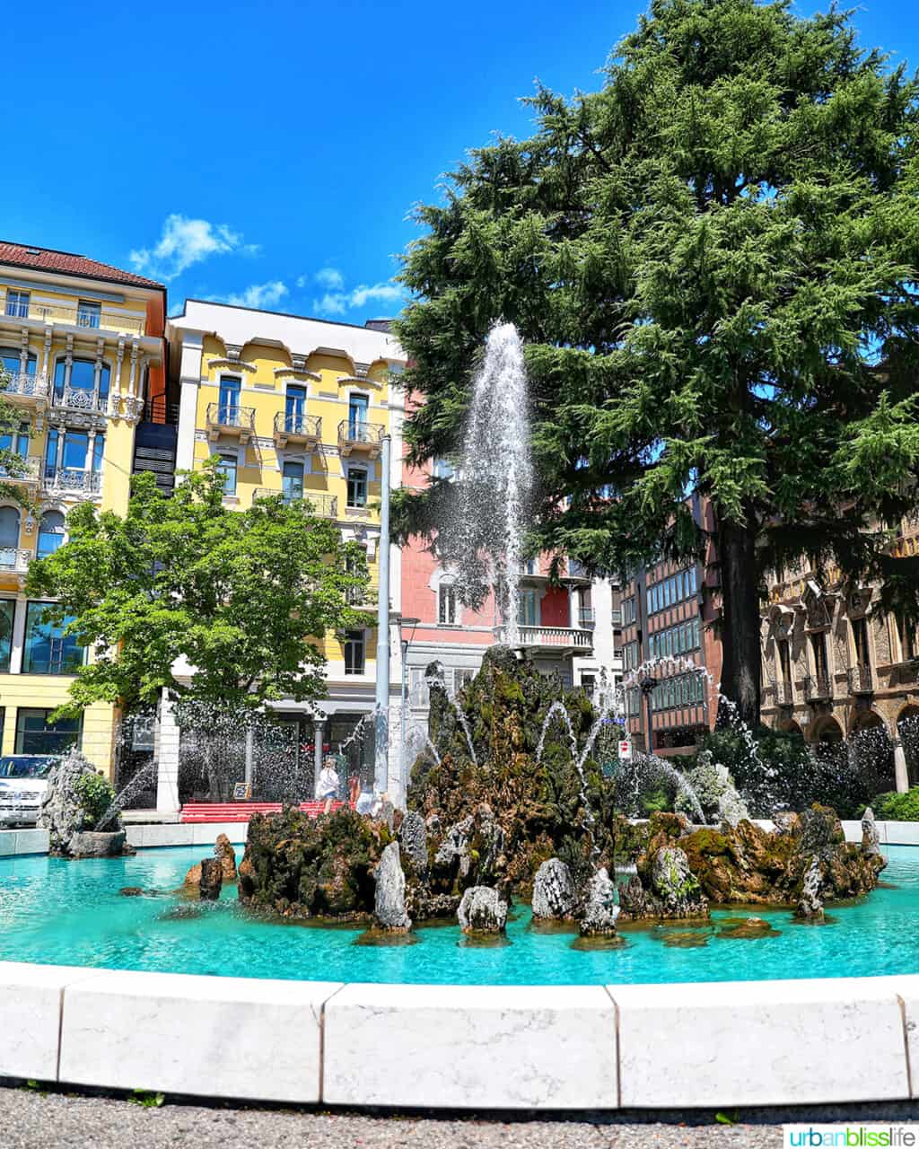 fountain against colorful buildings in Lugano, Switzerland