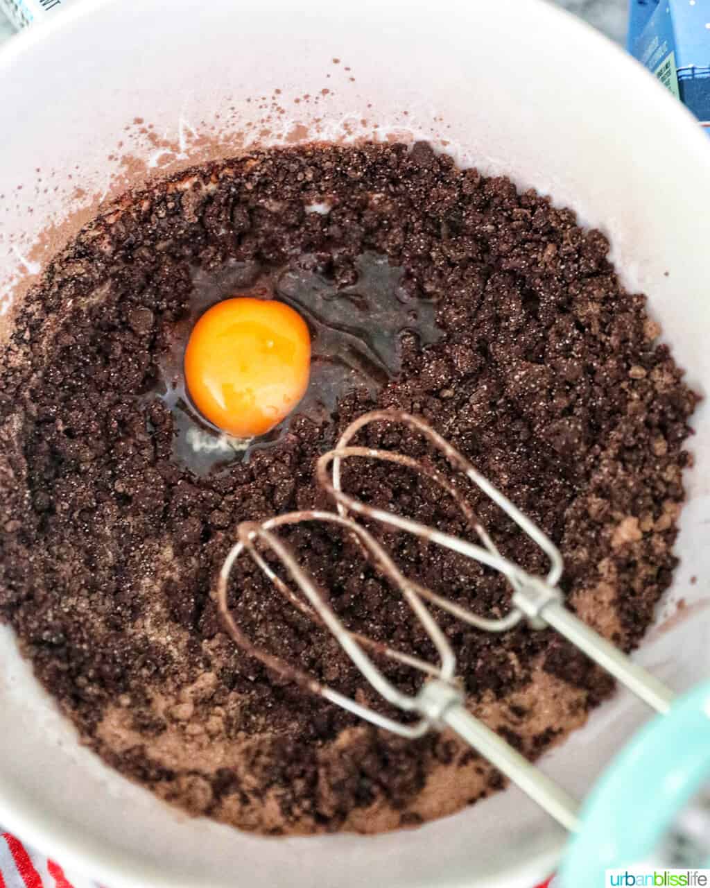 adding egg to brownie batter